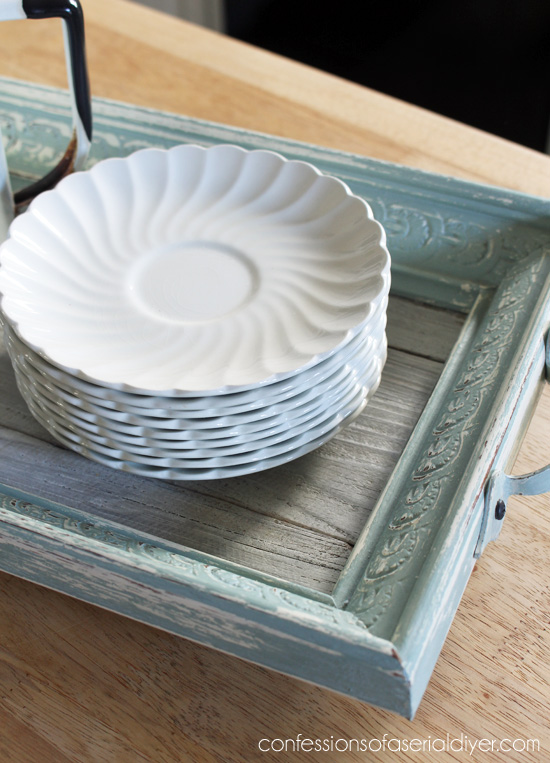 Turn a thrift store picture into a tray by painitng and adding a few old fence picket pieces to the bottom!