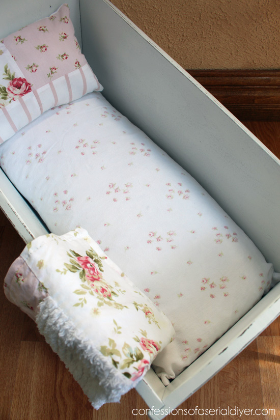 An old feather pillow form, cut in half, makes a great doll bed mattress!