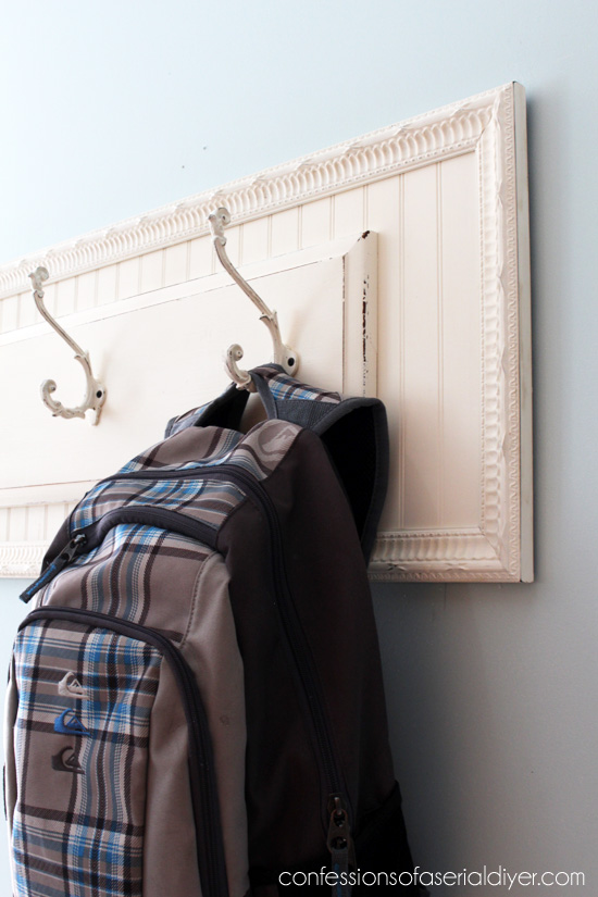 Pair an old drawer front and a thrift store frame to create a simple hanging rack!