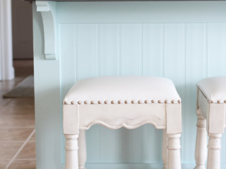 Barstools covered in white vinyl with chrome nailhead trim
