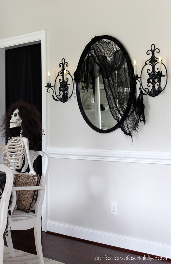 Halloween dining room skeleton party from confessionsofaserialdiyer.com