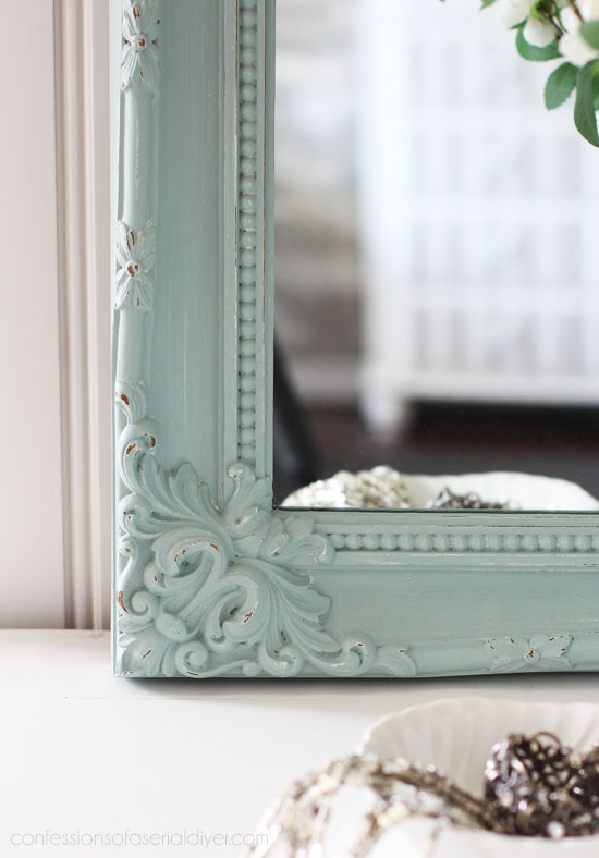 Gold thrift store mirror painted in a coastal hue.