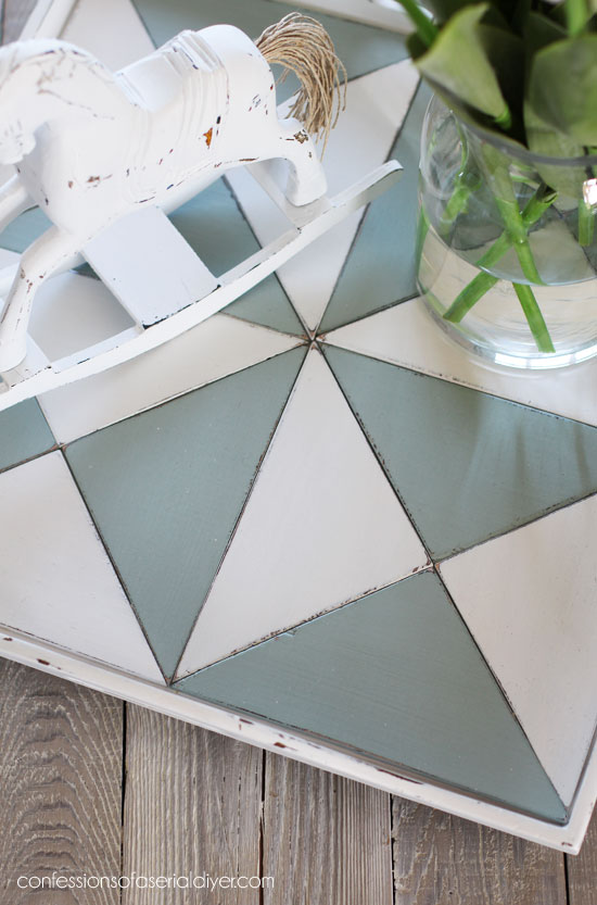 Cut pieces of luan to fit the bottom of a tray to create a quilt-inspired look.