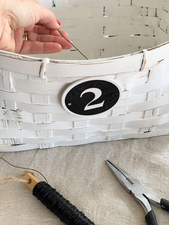 How to add a small sign to a basket with wire.