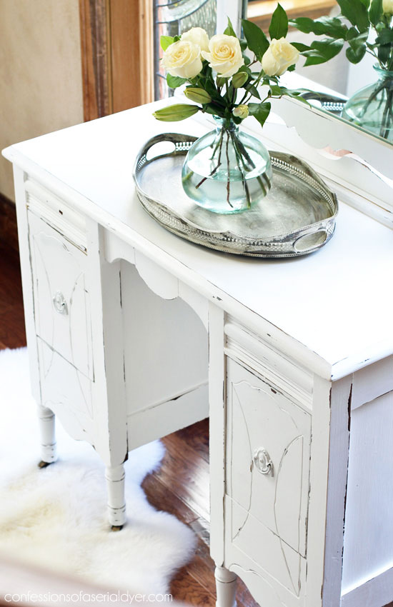 Close up of thrift store dressing table painted white and distressed