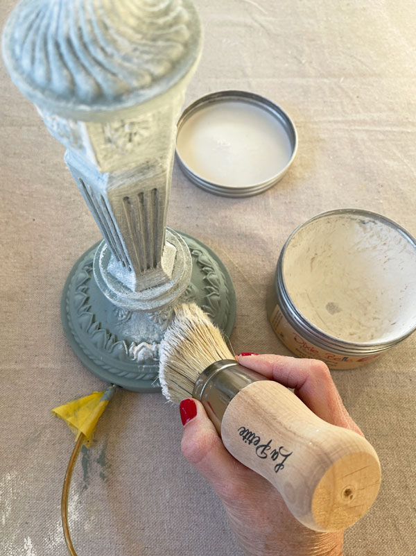 Applying white wax to a lamp