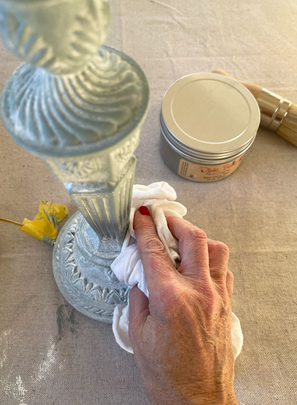 Applying white wax to a lamp