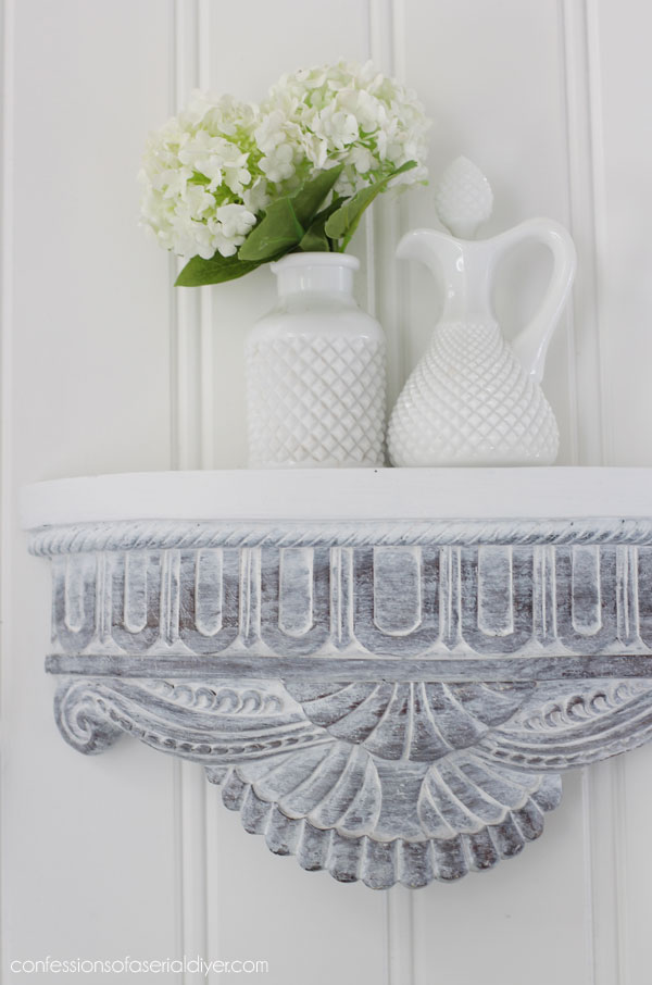 White washed carved wood shelves