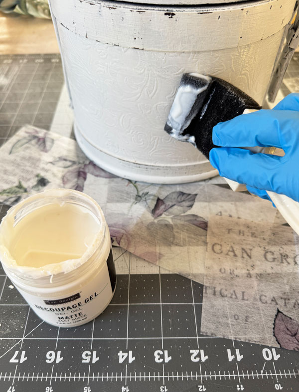 Applying decoupage paper to a wooden box