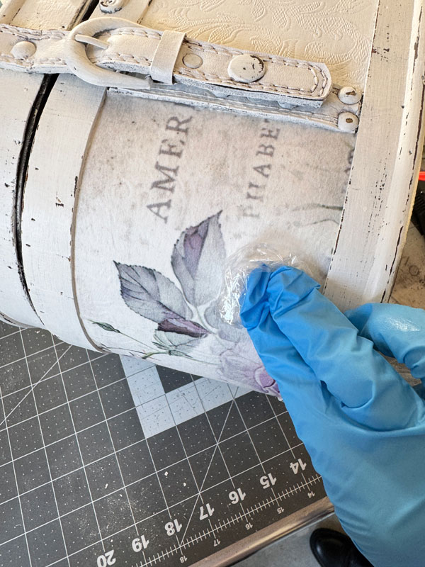 Applying decoupage paper to a wooden box