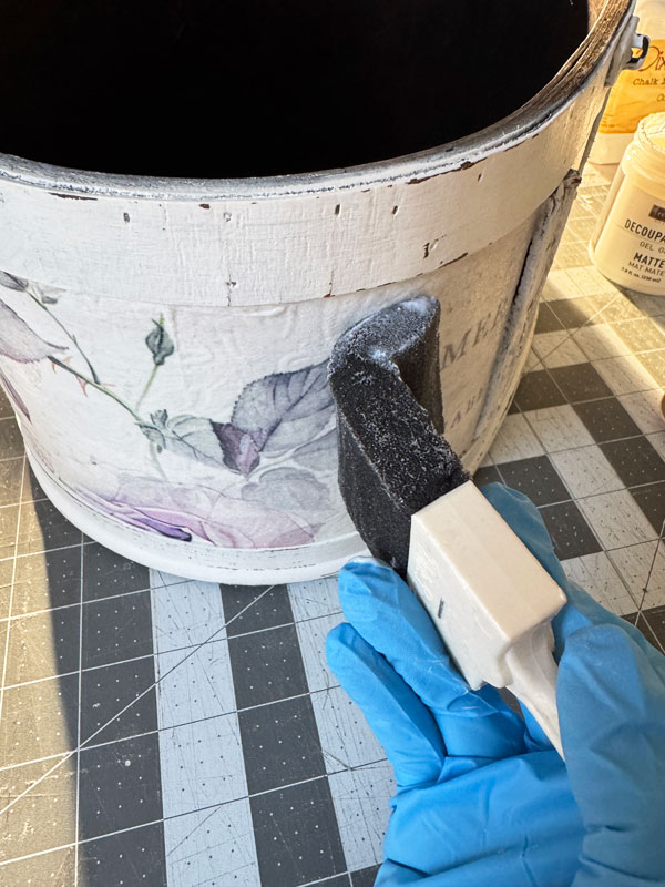 Applying decoupage paper to a wooden box