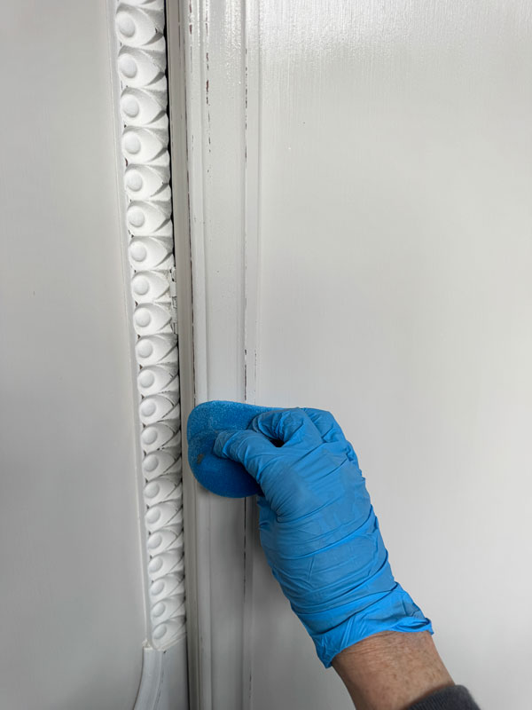 Applying Dixie Belle's Clear Coat using the blue sponge applicator.
