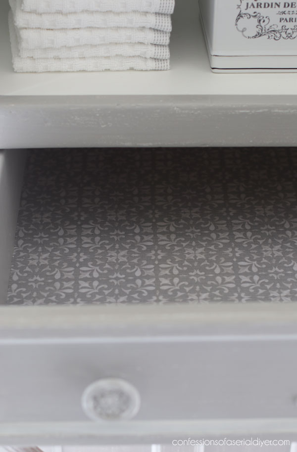 Lining the drawers with fabric.