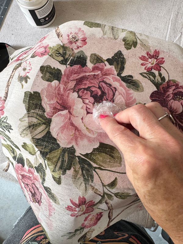 Adding decoupage paper to the top of a basket lid.