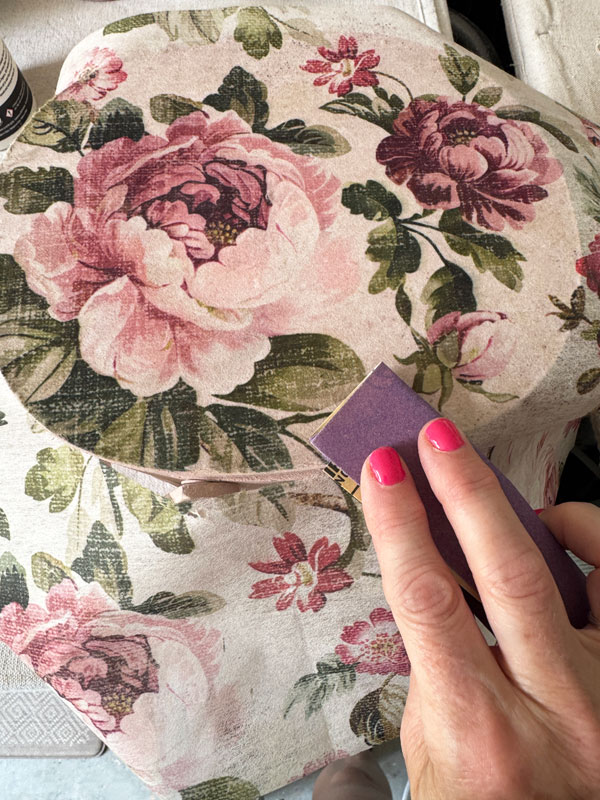Adding decoupage paper to the top of a basket lid.