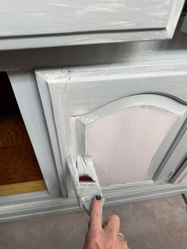 Applying a distressed paint finish to a hutch