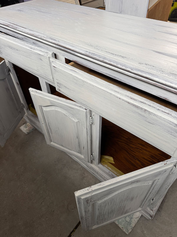 Applying a distressed paint finish to a hutch